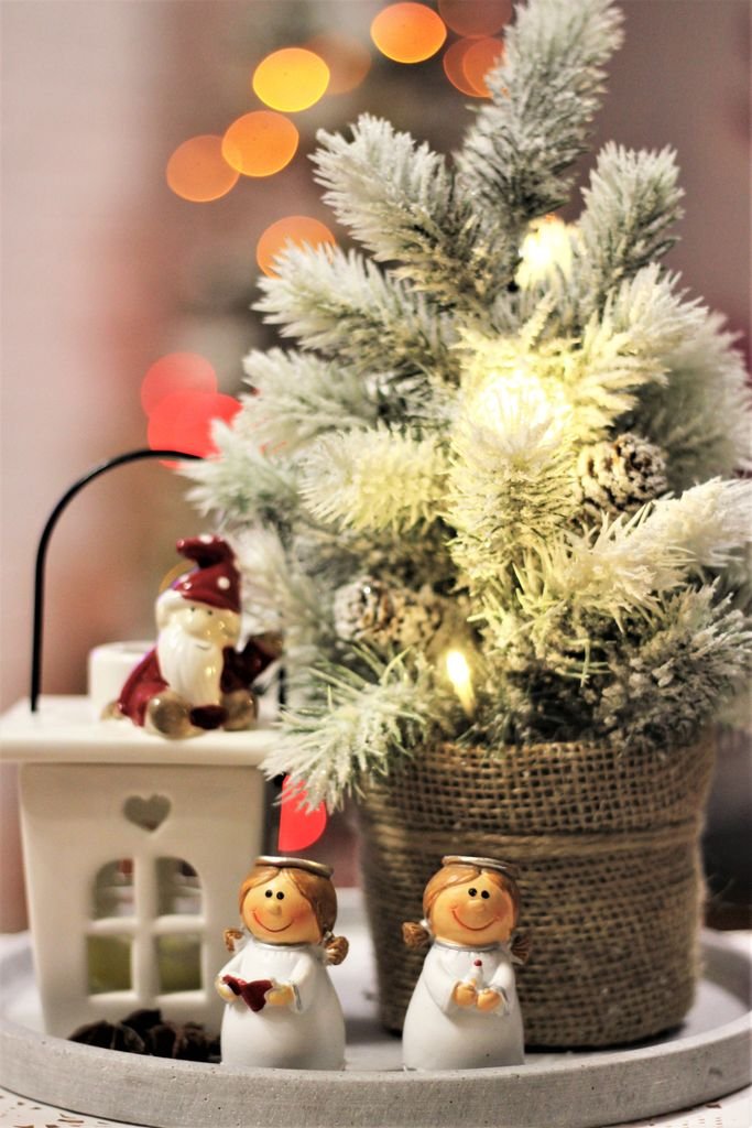 Cozy Christmas scene with decorations, including a mini Christmas tree and festive figurines.