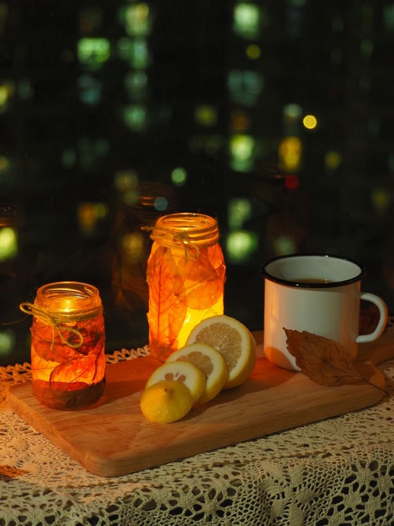 Warm night scene with candles and tea, perfect for a cozy ambiance.